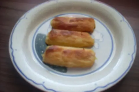 Drei goldbraune Gebäcke auf einem Teller, die an ein Fingernudeln Rezept erinnern.