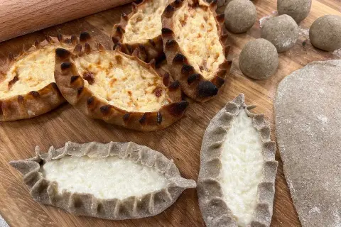 Piroger recept: Nybakade piroger med krämig fyllning och degbollar redo för ugnen.
