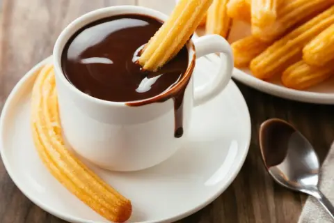 Churros recién hechos y chocolate caliente, un placer que te transporta a las mejores chocolaterías de Zaragoza.