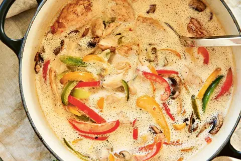 En krämig kycklinggryta med ris, full av färgglada paprikor och champinjoner. En härlig middag som värmer.