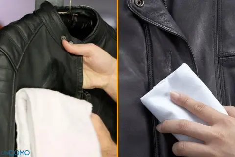 Entretien veste cuir : une main nettoie une veste en cuir noir avec un chiffon blanc.