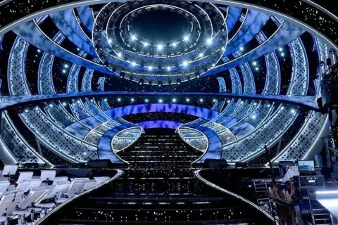 The dazzling stage for the San Remo Festival, illuminated with blue lights and starry effects, awaits its next performance.
