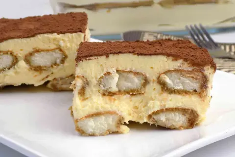 Pyszne tiramisu bez pieczenia, warstwowe, z biszkoptami i kremem, posypane kakao. Idealne na deser.