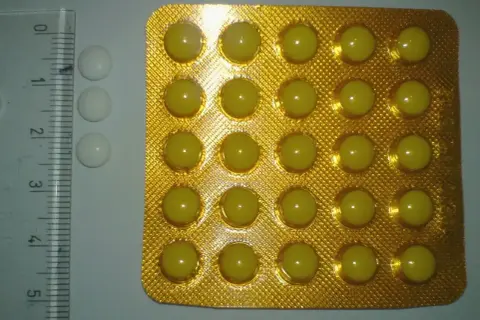 Opakowanie tabletek lorazepamu, obok linijki i kilku białych tabletek.