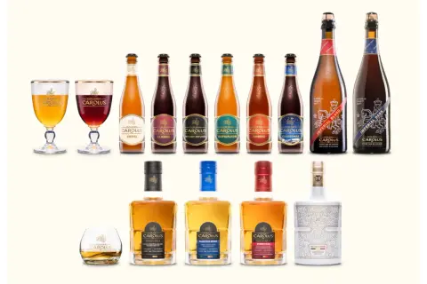 Una selezione di birre e whisky Gouden Carolus, con il loro iconico anker, in bottiglie e bicchieri eleganti.