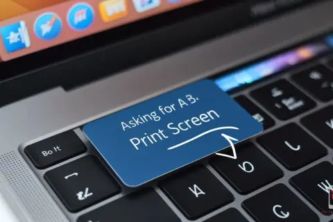 Niebieska naklejka na klawiaturze laptopa z napisem "Asking for A B. Print Screen". To jest screen.