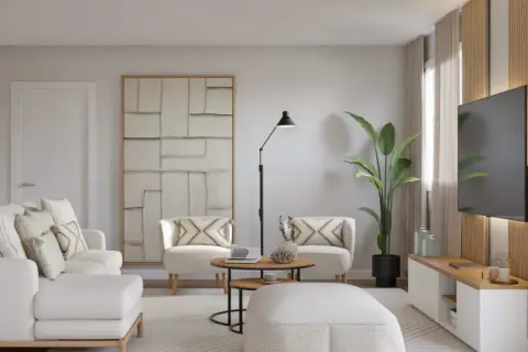 Un salón moderno y luminoso, ideal para aprender como decorar un salón con muebles blancos. Sofá, sillones y pouf blancos, con detalles en madera y arte abstracto.