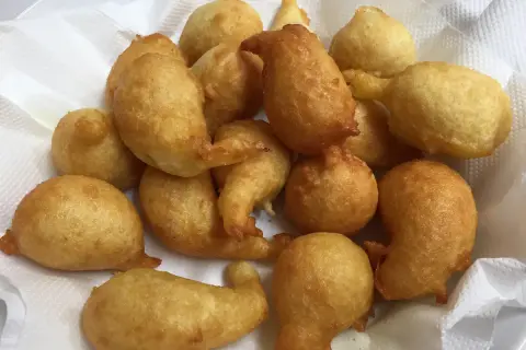 Un mucchio di pittule leverano dorate e fritte, pronte per essere gustate.