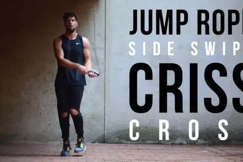 A man in athletic wear performs a jump rope routine, showcasing a "Criss Cross" move. He's as agile as Mike Tyson in his prime, mastering the jump rope.