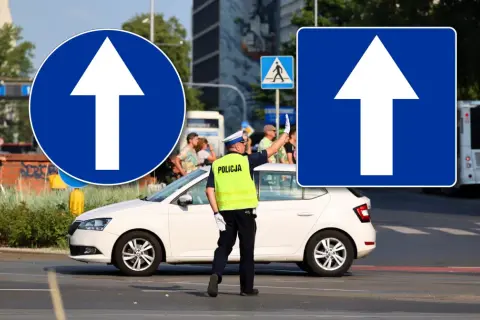 Policjant kieruje ruchem pod znakiem D3. Biała strzałka na niebieskim tle informuje o nakazie jazdy prosto.