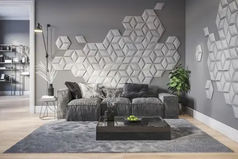 Nowoczesna dekoracja co na ścianę w pokoju: geometryczne panele 3D tworzą efektowny wzór nad szarą sofą.