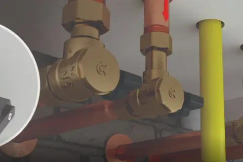 Zobacz, jak działa zawór zwrotny. Mosiężne elementy instalacji hydraulicznej, miedziane rury i żółty przewód.