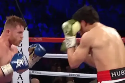 Boxers in a ring, one in a classic Mexican style boxing stance, throwing a punch.