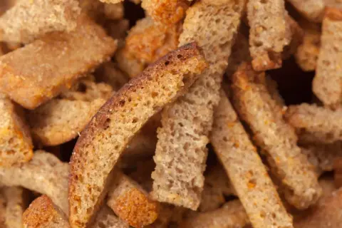 Zbliżenie na chrupiące grzanki z ciemnego pieczywa.