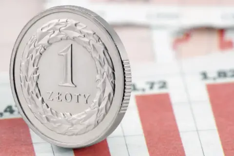 Moneta 1 złoty na tle wykresu. Czy to symbol tego, co to jest fundusz powierniczy?