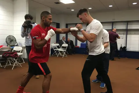 Boxers practice their moves, showing how to prepare for a fight. A cameraman films the training session.