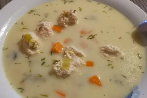 Kremowa zupa królewska z delikatnymi kluseczkami drobiowymi, marchewką i koperkiem. Pyszne danie na każdą okazję.