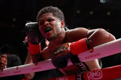 Boxer with green mouthguard grimaces, ready to deliver a powerful counter jab.