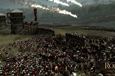 La batalla de Alesia en pleno apogeo. Legiones romanas asedian una fortaleza gala, con fuego y humo en el cielo.