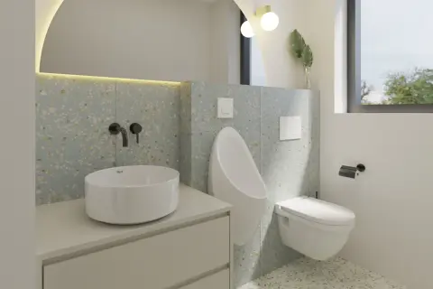 Modernos baños alicatados a media altura con lavabo sobre encimera, urinario y cisterna empotrada.