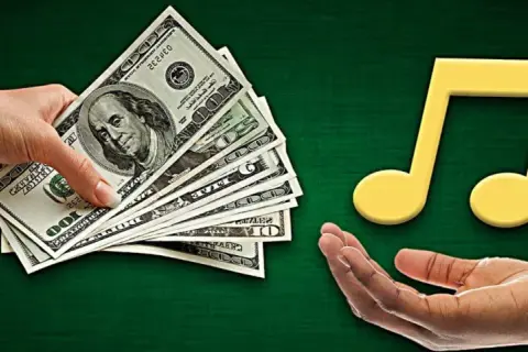 Hands exchange money for a musical note, symbolizing music funding.
