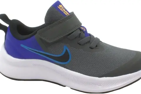 Scarpa Nike grigia con dettagli blu e viola, chiusura a velcro. Perfetta per ogni avventura, che tu sia grande o piccolo.