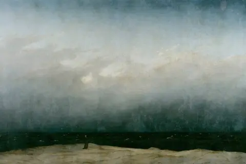 The wanderer painting depicts a solitary figure on a desolate shore, gazing out at a turbulent sea under a dramatic, cloudy sky.
