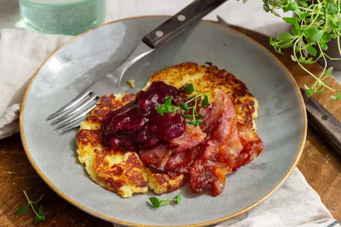 Stekta potatisbullar av potatismos toppas med lingonsylt och knaperstekt bacon. En klassisk svensk rätt som väcker aptit.