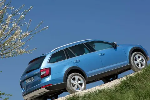 Niebieska Skoda Octavia 2 na tle błękitnego nieba, z widocznymi oponami i felgami.