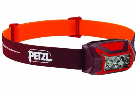 Lampe frontale Petzl rouge et orange, idéale pour choisir votre éclairage d'aventure.