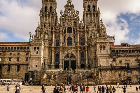 Majestuosa fachada de una de las catedrales barrocas más impresionantes, con gente paseando en la plaza.