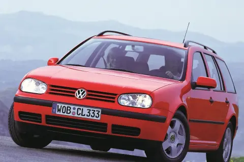 Czerwony Volkswagen Golf 4 Variant z uśmiechniętymi pasażerami. Widać przednie światła i grill, ale nie ma tu golf 4 żarówki tylne.