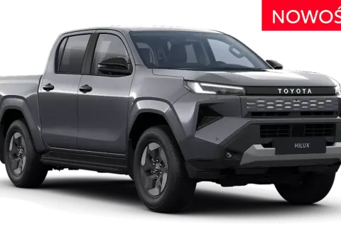 Nowy, szary Toyota Hilux pickup z nowoczesnym grillem i światłami LED. Czerwony napis "NOWOŚĆ" informuje o premierze.