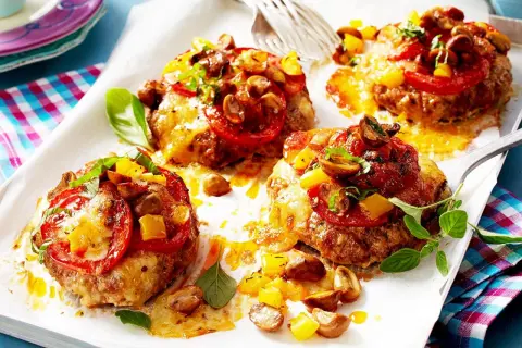 Vier Hackfleisch-Patties mit geschmolzenem Käse, Tomaten, Pilzen und Paprika. Perfekt für schnelle Hackfleisch Rezepte!