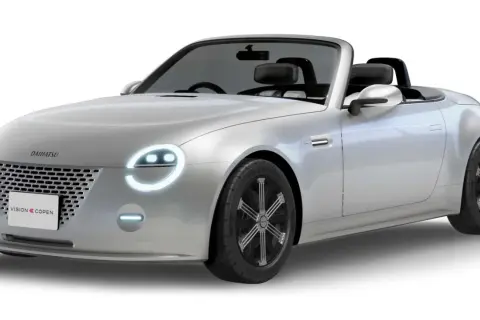 Srebrny kabriolet Daihatsu Vision Copen z okrągłymi światłami i sportowymi felgami.