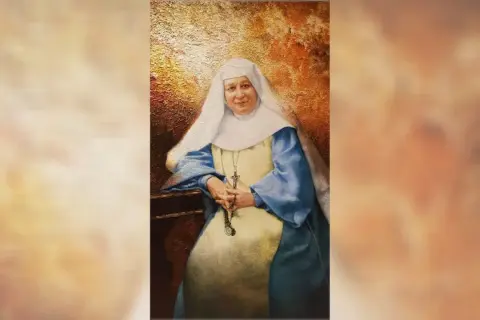 Retrato de María Emilia Riquelme, una monja con hábito blanco y azul, sosteniendo un rosario.