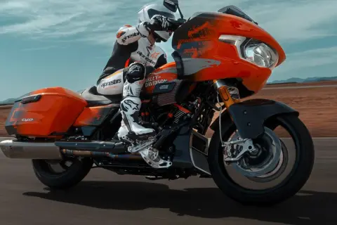 Pomarańczowy Harley-Davidson CVO z kierowcą w kombinezonie Alpinestars, pędzący po pustynnej drodze. To może być najdroższy motor na świecie.