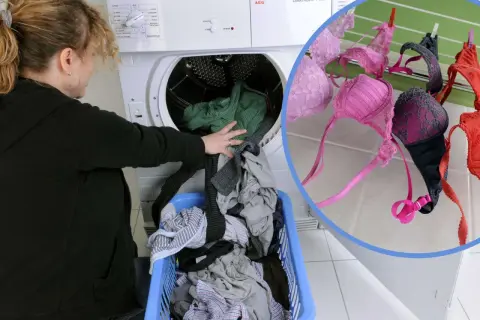 Frau lädt Wäsche in den Trockner. BHs trocknen an der Leine.