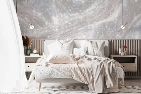 Traumhafte schlafzimmer wand ideen mit einer Tapete im Sternenhimmel-Design. Gemütliches Bett mit vielen Kissen und Decken.