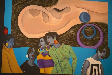A surreal painting by hispanic artists features women with striking jewelry and bold outfits, set against a backdrop of a giant ear and swirling hair.