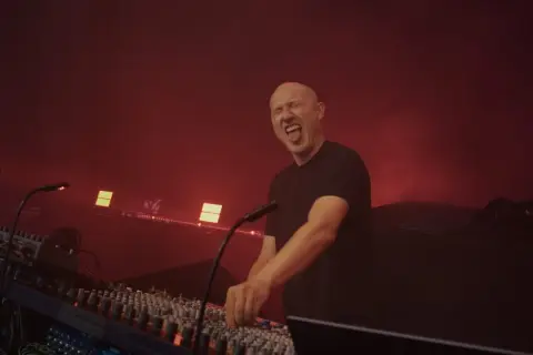 Paul Kalkbrenner na koncertach w Polsce, w transie za konsolą, z językiem na wierzchu.