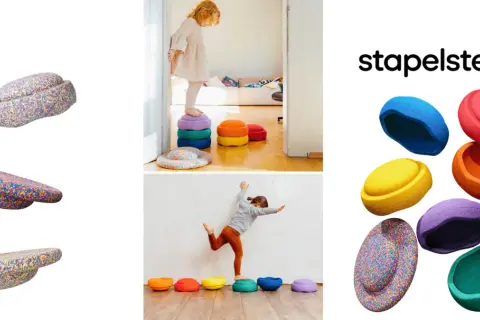 Bunte Stapelsteine regen Kinder zu kreativen Spielideen an. Kinder balancieren und stapeln die bunten Steine.