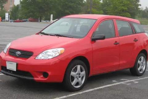 Czerwony Toyota Matrix stoi na parkingu.