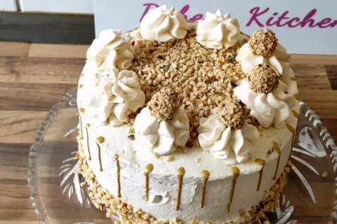 Eine köstliche Giotto Torte, verziert mit Nüssen, Sahnetupfern und Schokokugeln, bereit zum Genießen.
