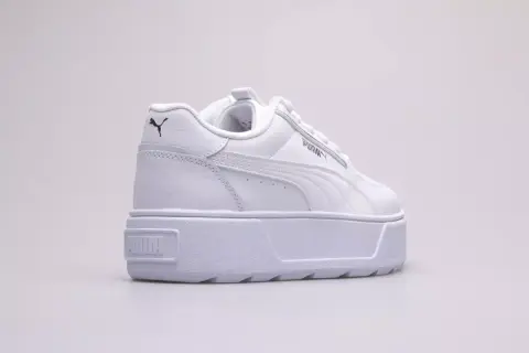 Białe buty na platformie Puma Karmen Rebelle Jr. z czarnym logo.