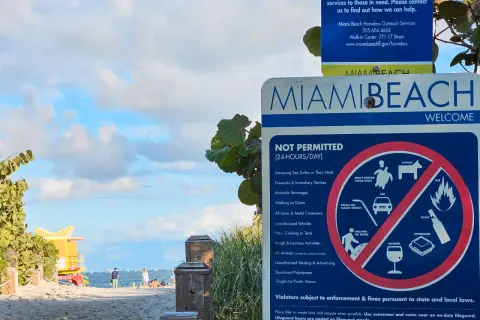 Tablica informacyjna na plaży w Miami Beach, gdzie leży to słynne miasto. Widać zakazy, np. alkoholu i plastikowych słomek.