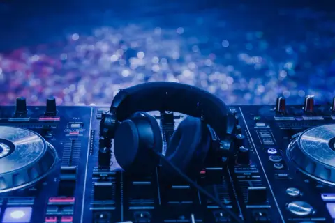Słuchawki na konsoli DJ-skiej, gotowe do akcji. Czy to będzie kolejna niezapomniana noc z muzyką Tiesto w Polsce?