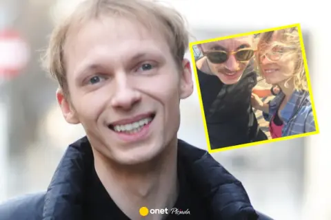 Igor Herbut z żoną na zdjęciu. Uśmiechnięty wokalista i jego ukochana w słoneczny dzień.