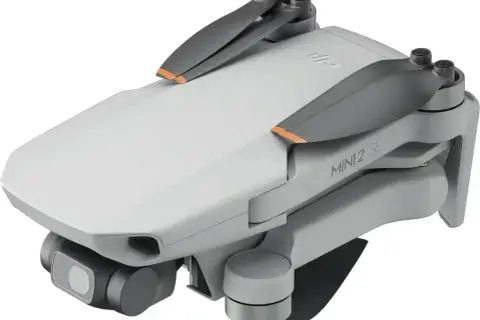 Składany dron DJI Mini 2 SE z kamerą i pomarańczowymi akcentami na śmigłach. Idealny do nauki trików w powietrzu.