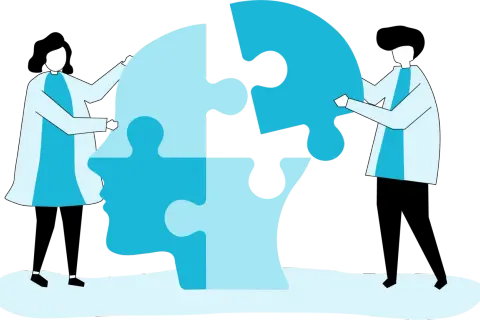 Dwie osoby składają puzzle w kształcie głowy, symbolizując terapię behawioralną i proces zrozumienia siebie.